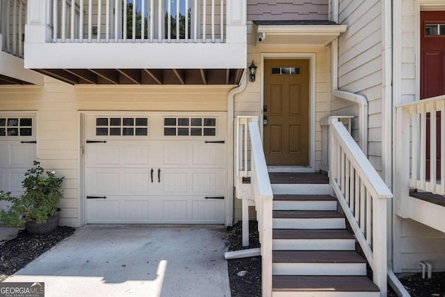 doorway to property featuring a balcony and a garage