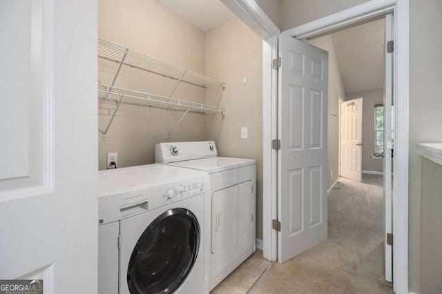 laundry area with washing machine and dryer and light colored carpet