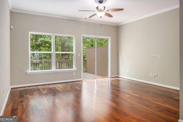 spare room featuring ceiling fan, dark wood-type flooring, and ornamental molding