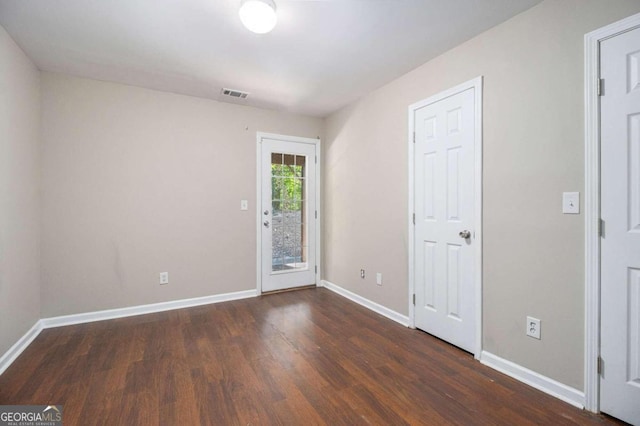 spare room featuring dark hardwood / wood-style flooring