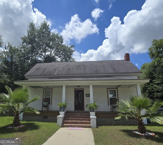 bungalow-style house featuring a front yard