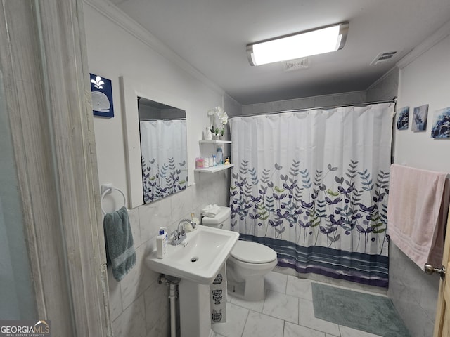 bathroom featuring toilet, walk in shower, ornamental molding, and sink