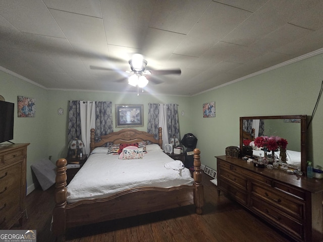 bedroom featuring ceiling fan, dark wood-type flooring, and ornamental molding