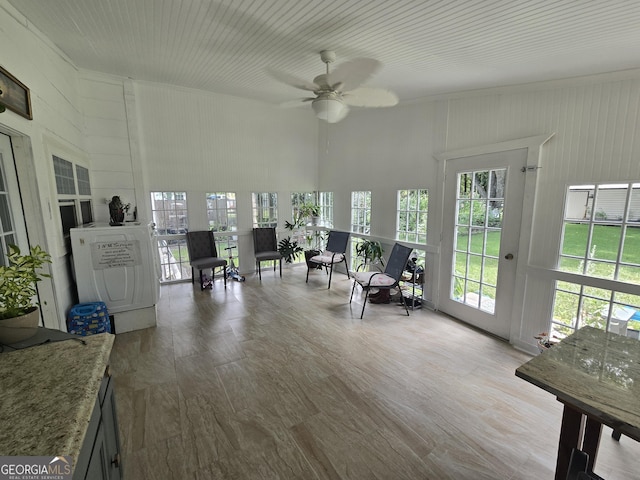 sunroom / solarium featuring ceiling fan