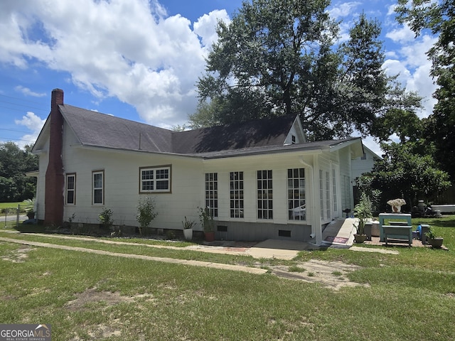 back of house with a yard