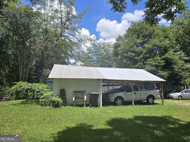 view of vehicle parking with a carport and a yard