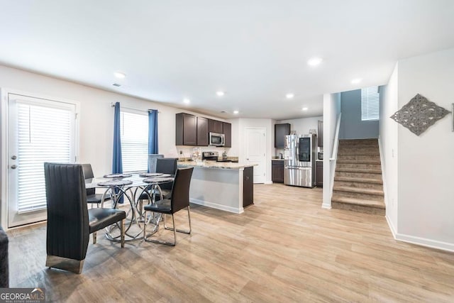 dining space with light hardwood / wood-style flooring