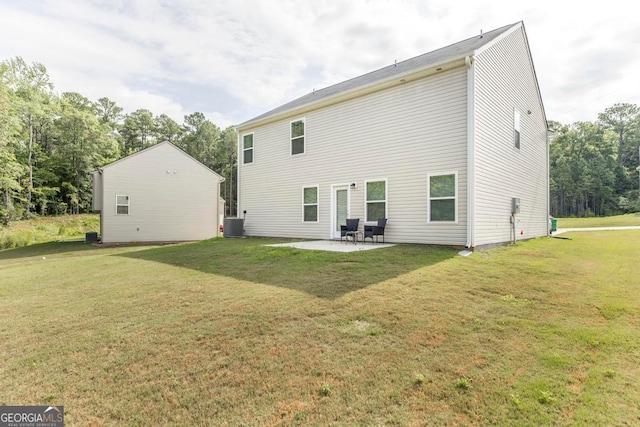 back of house featuring central air condition unit, a patio, and a yard