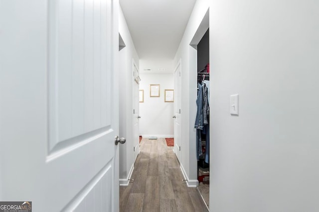 hallway with wood-type flooring