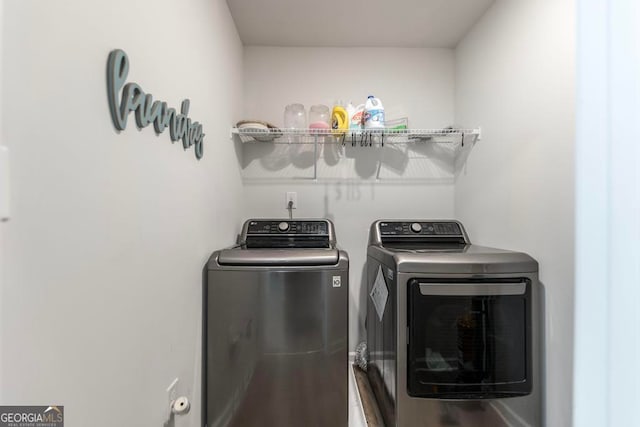 clothes washing area featuring washer and clothes dryer