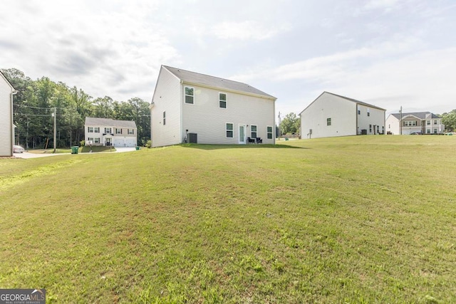 rear view of house featuring a yard