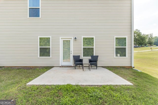 back of house featuring a patio and a lawn