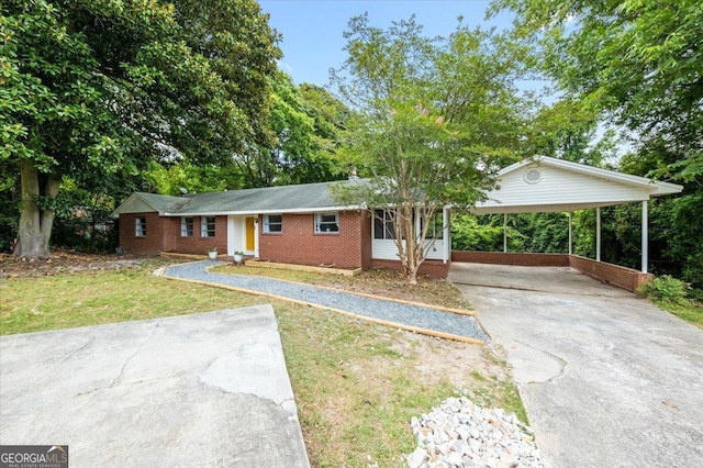 ranch-style house featuring a carport and a front lawn