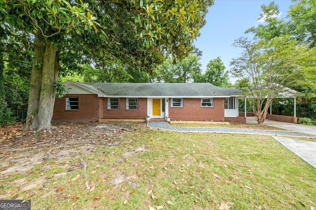 single story home with a front lawn and a carport