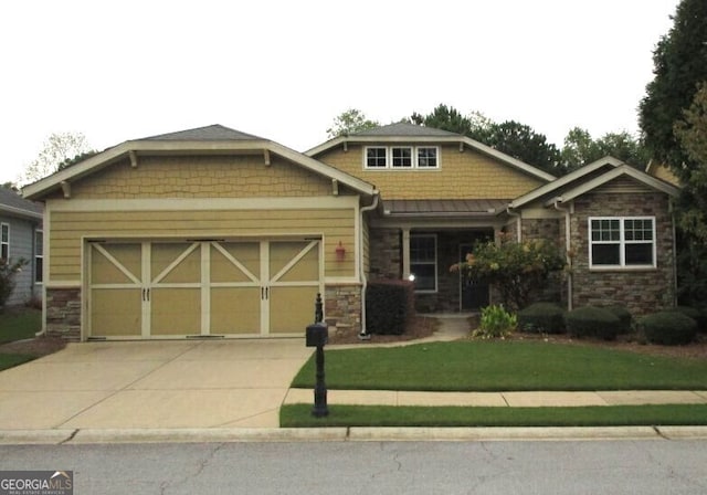 craftsman-style house featuring a front lawn and a garage