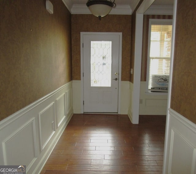 doorway to outside with wood-type flooring and ornamental molding