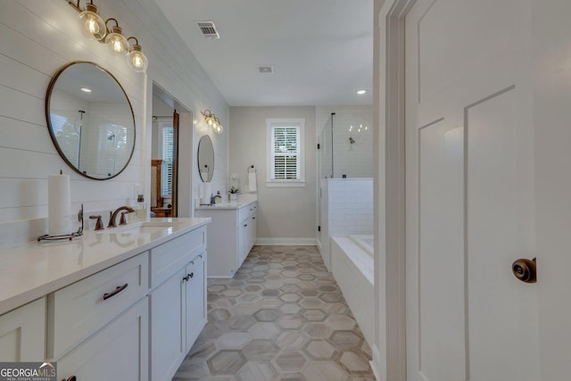 bathroom with tile patterned floors, vanity, and plus walk in shower