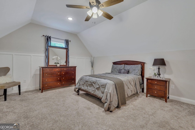 carpeted bedroom with ceiling fan and vaulted ceiling