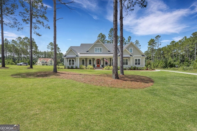 craftsman house featuring covered porch and a front lawn