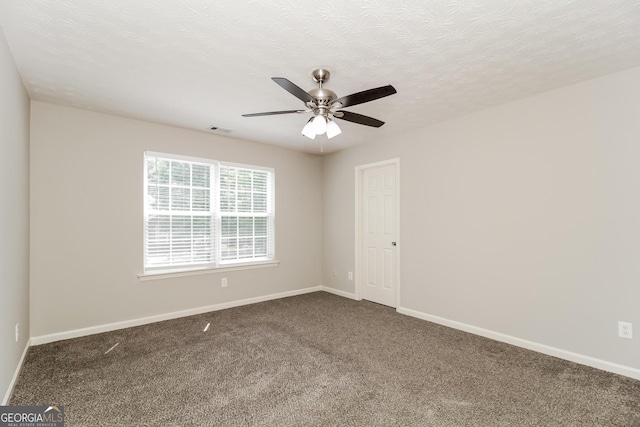 spare room with ceiling fan, a textured ceiling, and carpet flooring