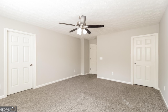 unfurnished room with ceiling fan, a textured ceiling, and carpet flooring