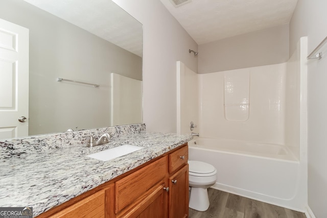 full bathroom featuring toilet, vanity, shower / bathtub combination, and hardwood / wood-style flooring