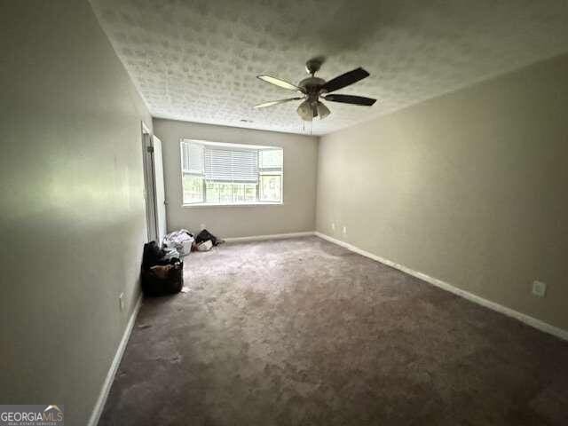 carpeted empty room with ceiling fan