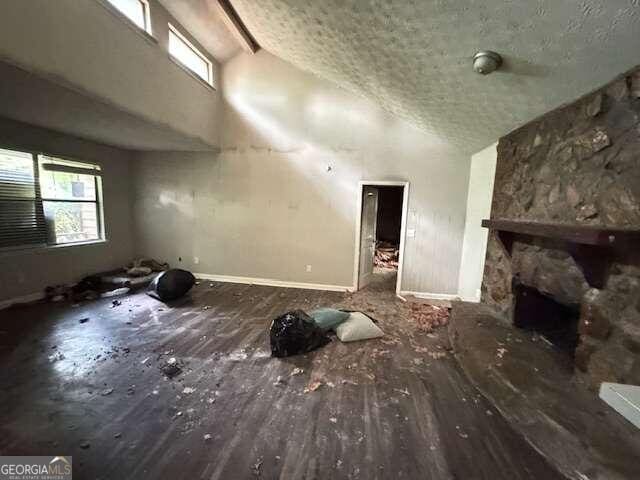 misc room with a fireplace, a textured ceiling, and a wealth of natural light