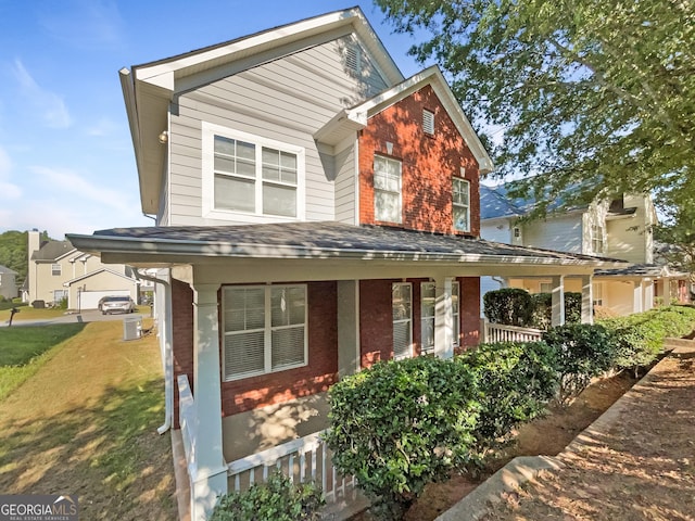 view of front facade featuring a porch and a garage