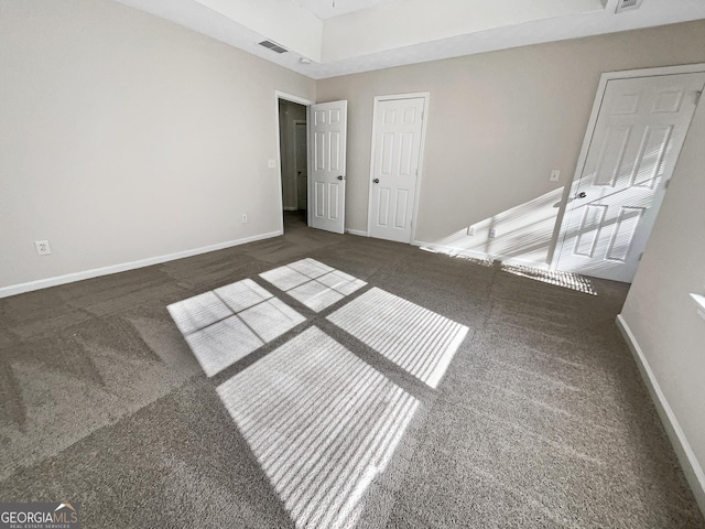 unfurnished bedroom with dark carpet