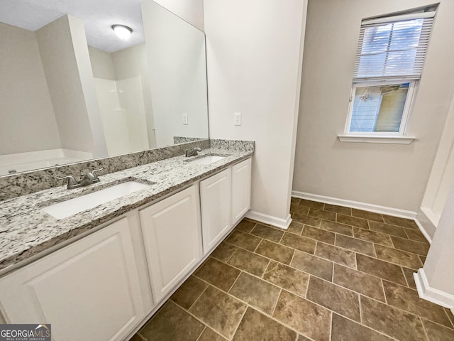 bathroom with tile patterned floors and vanity