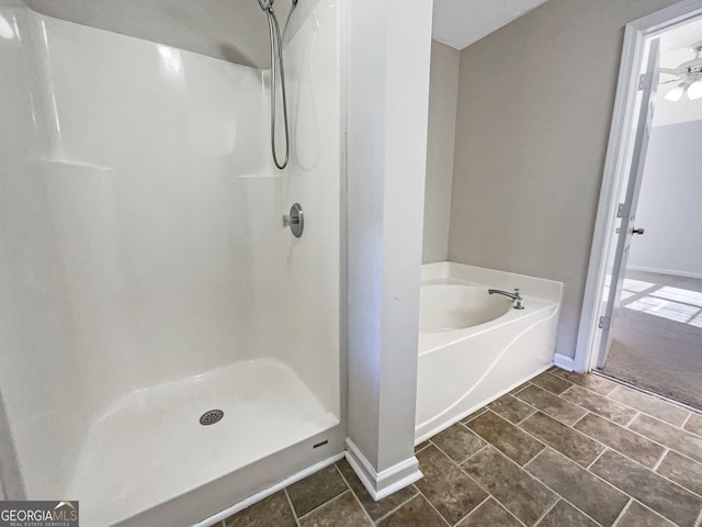 bathroom with separate shower and tub and tile patterned flooring