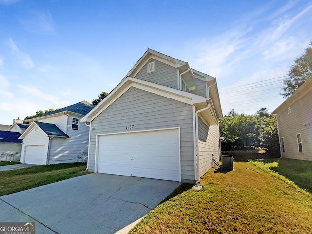 view of front facade with a garage, central AC unit, and a front yard