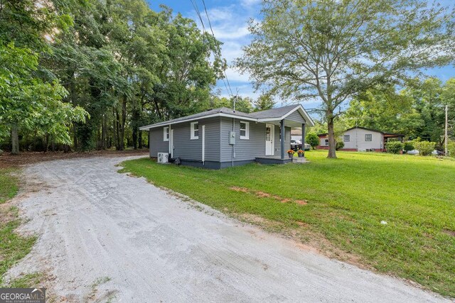 view of property exterior with a yard