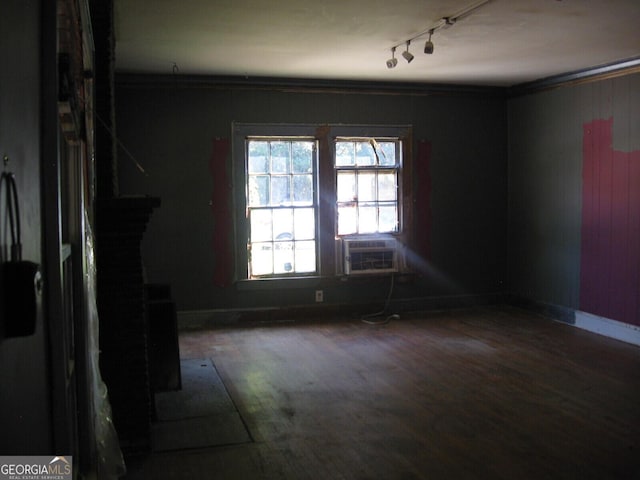 spare room featuring crown molding, track lighting, and hardwood / wood-style flooring