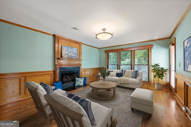 living room featuring light hardwood / wood-style flooring and ornamental molding