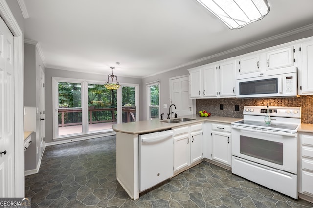 kitchen with sink, white appliances, dark tile patterned flooring, and tasteful backsplash