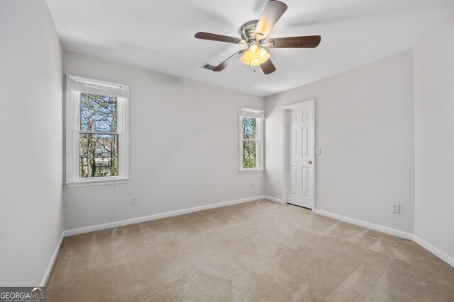 bedroom with ceiling fan, carpet flooring, crown molding, and a tray ceiling