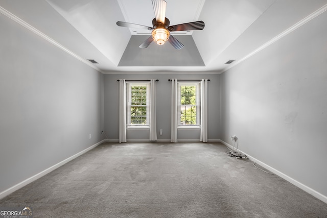 unfurnished room with ceiling fan, a raised ceiling, carpet floors, and ornamental molding