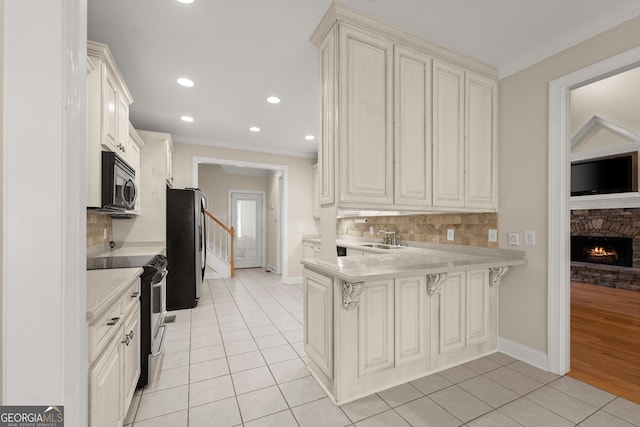 kitchen featuring kitchen peninsula, sink, light tile patterned floors, and stainless steel appliances