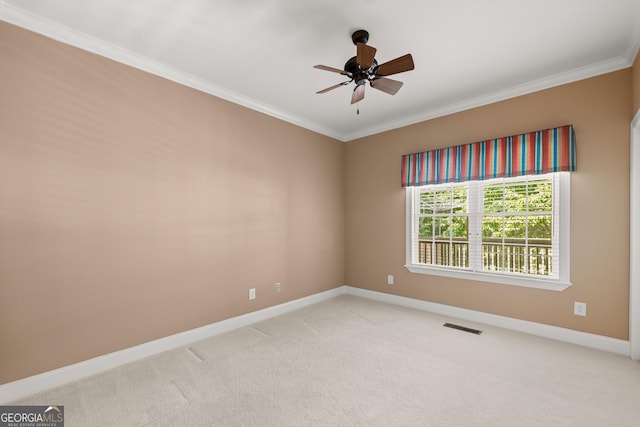 empty room with light colored carpet, ceiling fan, and crown molding