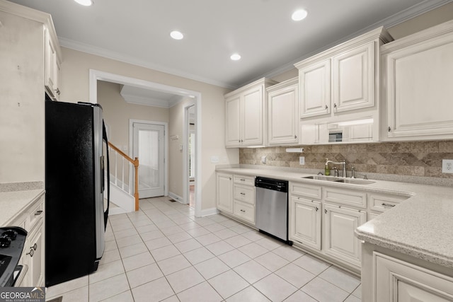 kitchen featuring white cabinets, light tile patterned floors, sink, and appliances with stainless steel finishes