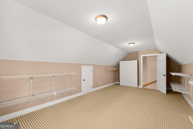 bonus room with carpet and vaulted ceiling