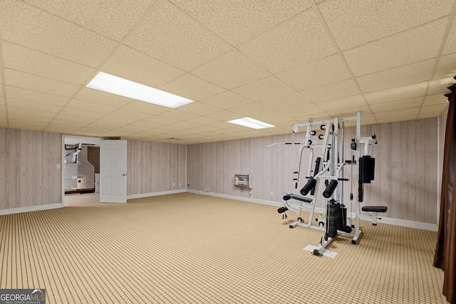 workout area featuring carpet flooring, heating unit, and a paneled ceiling