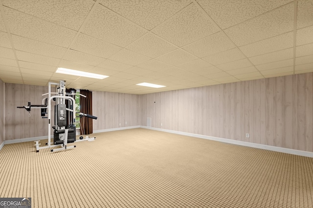 exercise area with a paneled ceiling and carpet flooring