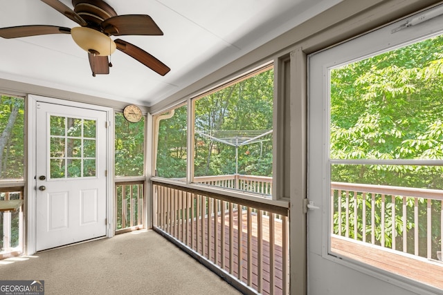 unfurnished sunroom with ceiling fan