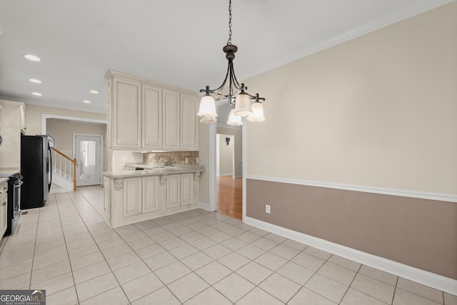 kitchen featuring pendant lighting, light tile patterned floors, ornamental molding, and a notable chandelier