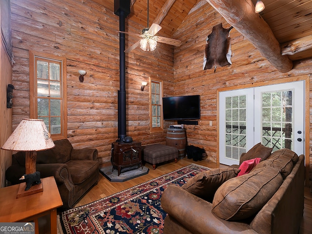 living room featuring wood ceiling, beamed ceiling, hardwood / wood-style floors, high vaulted ceiling, and ceiling fan