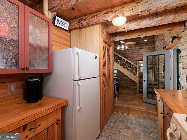 kitchen featuring beam ceiling, ceiling fan, dark hardwood / wood-style floors, wooden counters, and white appliances