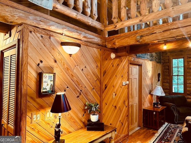 interior details with wood walls and wood-type flooring